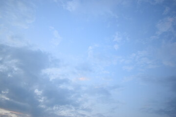 beautiful blue sky and white fluffy group of clouds with sunrise in the morning, natural background