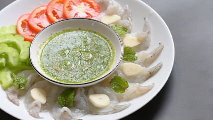 shrimp in fish sauce with Thai spicy seafood dipping sauce on white plate