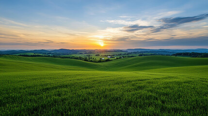 Obraz premium Beautiful Sunrise Over Lush Green Rolling Hills and Fields in Countryside Landscape