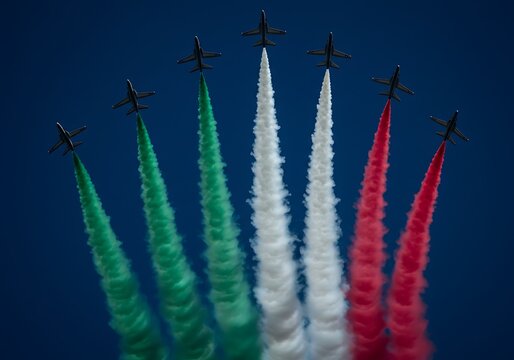 Aerobatic Team Performing with Colored Smoke Against Blue Sky Backdrop