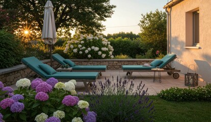 Obraz premium Garden patio at sunset with lounge chairs and colorful hydrangeas,