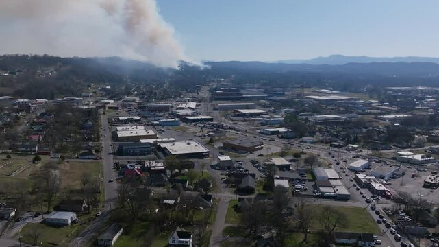 Aerial drone footage of the intersection of Dodds Ave and Rossville Blvd with a large forest fire in Rossville, Georgia in the background.