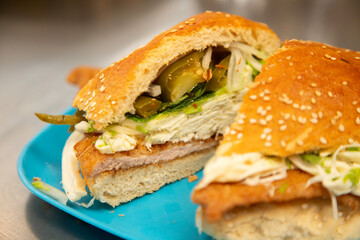 Cemita Poblana. A traditional Mexican sandwich with breaded pork and chipotle chili, quesillo cheese, and papalo leaves.