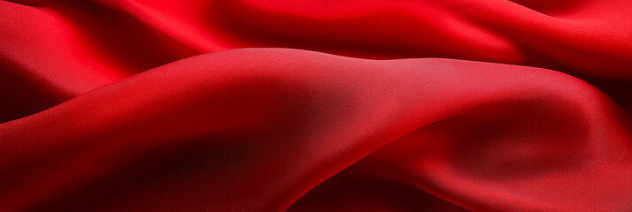 Obraz premium a close-up of a luxurious red fabric with elegant folds, soft and flowing. The image captures the texture and subtle variations of the material.
