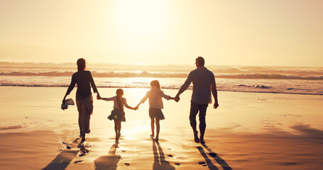 Fototapeta premium Sunset, family and holding hands at beach for holiday, vacation and bonding together outdoor. Back, mother and father with children at ocean with mockup space, travel or summer adventure with parents