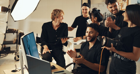 Happy people, studio or clapping for photography success for production results, project or review. Photographers, producer or computer to check for teamwork, magazine catalog or filming achievement