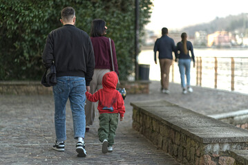 Young family on the promenade on Lake Lugano.