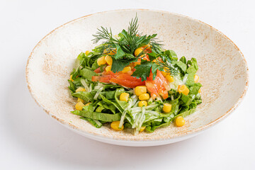 Crisp greens topped with corn, smoked salmon, and vibrant herbs create a refreshing dish