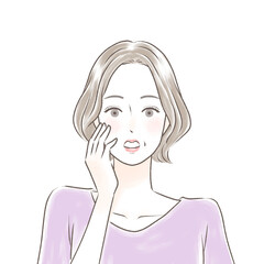 顔に手を当てて驚く綺麗なシニア女性　