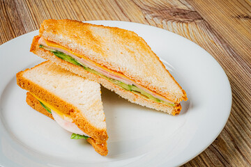 Fresh sandwich on crisp bread, loaded with veggies and meats, beautifully plated