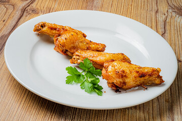 Tasty chicken wings are perfectly cooked and presented with fresh parsley, enhancing their flavor