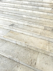 A set of white marble steps with a white railing