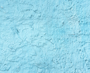 A blue wall with a rough texture