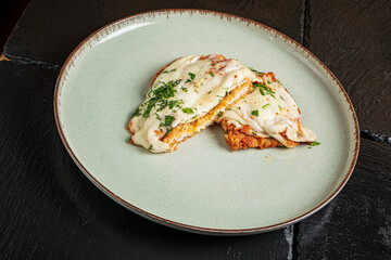 Savory melted cheese oozes from a perfectly baked dish, highlighting rich flavors and textures