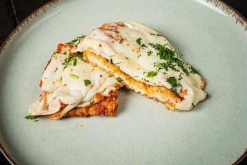 Juicy chicken breast drizzled with rich cheese and sprinkled with vibrant herbs adds elegance