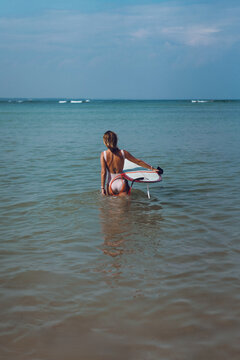 Happy wet woman surfing in the ocean
