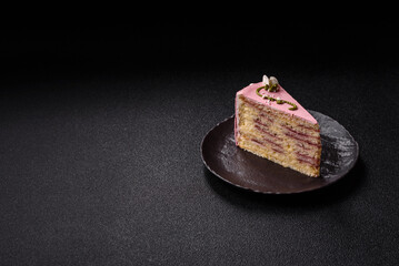 A piece of pink layered cake with strawberry flavor
