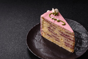 A piece of pink layered cake with strawberry flavor