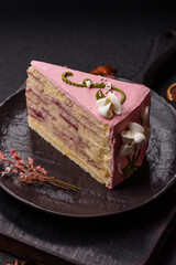 A piece of pink layered cake with strawberry flavor