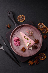 A piece of pink layered cake with strawberry flavor