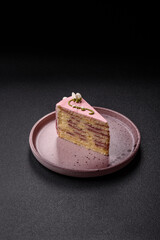 A piece of pink layered cake with strawberry flavor