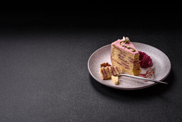 A piece of pink layered cake with strawberry flavor