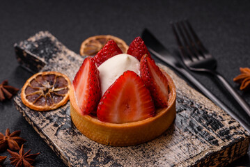 Round sweet tart with strawberry pieces and cream