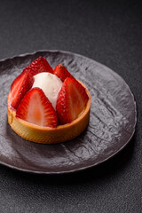 Round sweet tart with strawberry pieces and cream