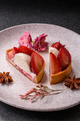 Round sweet tart with strawberry pieces and cream