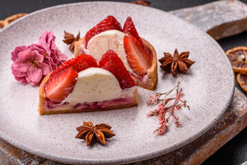 Round sweet tart with strawberry pieces and cream