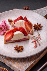 Round sweet tart with strawberry pieces and cream