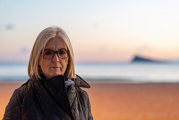 Portrait of a Woman on a Beach at Sunset with Serene Background