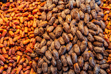A colorful mix of premium dried dates on display at a market. Popular during Ramadan for breaking the fast, dates are a healthy, energy-rich fruit full of natural sweetness and fiber.