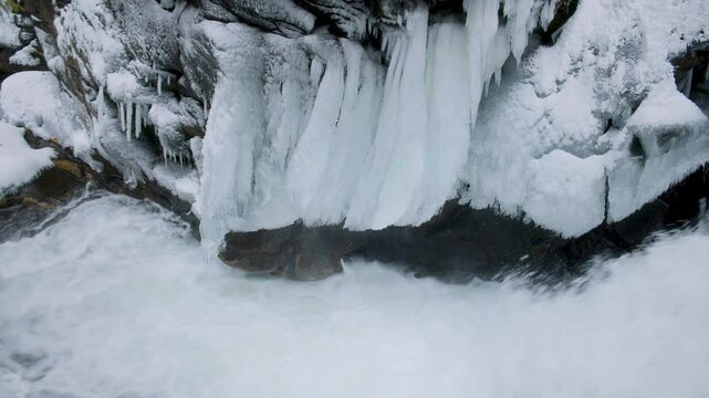 Cold Winter Nature Background with Icicles Above Waterfall