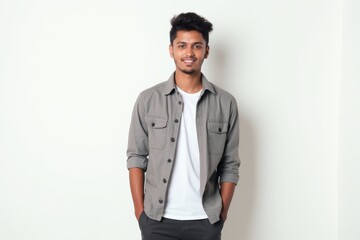 Fototapeta premium Half-Length (Waist-Up) portrait of young stylish smiling Nepalese male model in preppy wear isolated on pure white background looking at camera