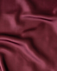 Red wine color silk background. Minimal background and texture concept. Trendy cloth backdrop. Flat lay style wallpaper. Top view banner. Copy space.
