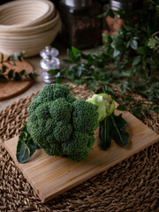 Organic Raw Fresh Green Broccoli on wooden board. Vegetables for diet and healthy eating.