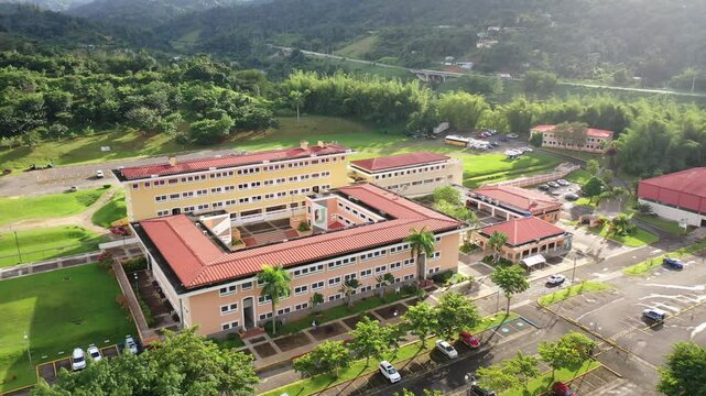 Drone landscape footage of UPR - University of Puerto Rico in Utuado surrounded by green spaces