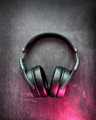 Beautiful, black, full-size headphones on a black background.