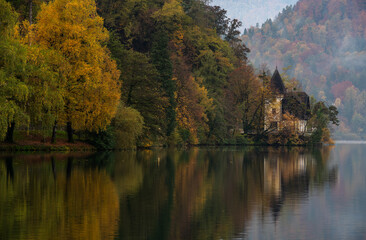Autumn landscape with colorful trees and calm waters at a serene lake in the mountains