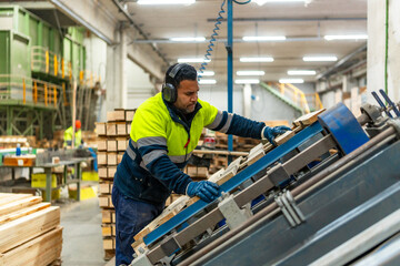 Worker of a recycling plant repairing a pallet for reuse