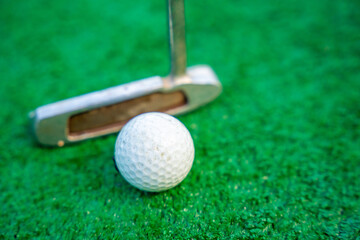 Mini-golf clubs and balls on artificial grass. Family vacations or resort. 