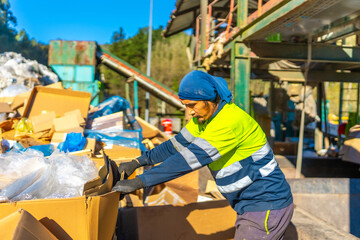 Fototapeta premium Man separating materials outside a recycling plant