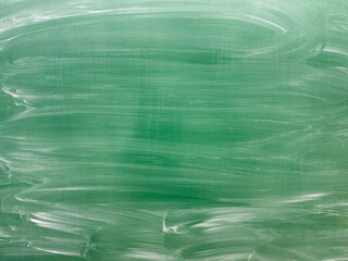 Clean Green Chalkboard with Eraser Marks in Classroom Setting