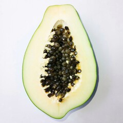 Raw green papaya isolated on white background. Slice papaya. Half papaya. Close up