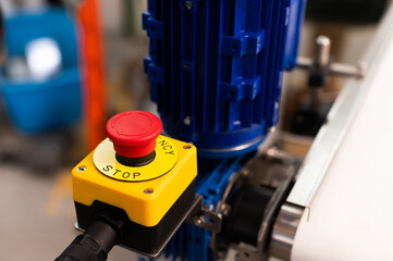 A red Emergency STOP button used for safety on industrial equipment, machine machinery electrical...