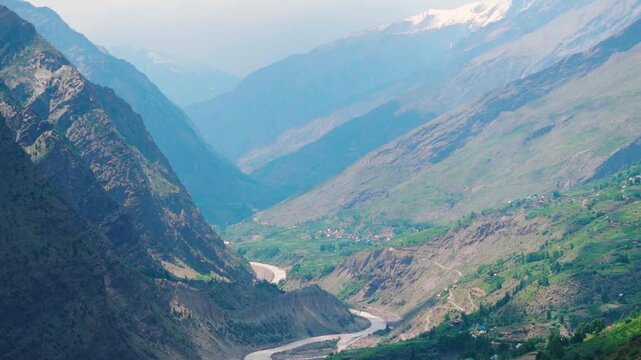 ChandraBhaga river flowing between the Himalayan mountains of the Pattan Valley as seen from Marbal village in Lahaul and Spiti district, Himachal Pradesh, India. Scenic view of river in Lahaul valley