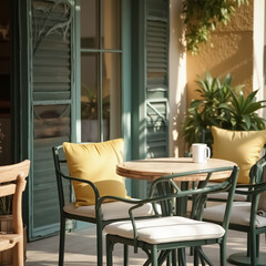 Obraz premium sunlit outdoor patio with a round wooden table and metal chairs