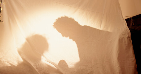 Family, shadow and playing with kid in tent for bonding, storytelling and childhood adventure....