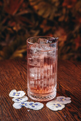 beautiful cocktails in warm colors on a flower background. cocktail or bar menu concept.